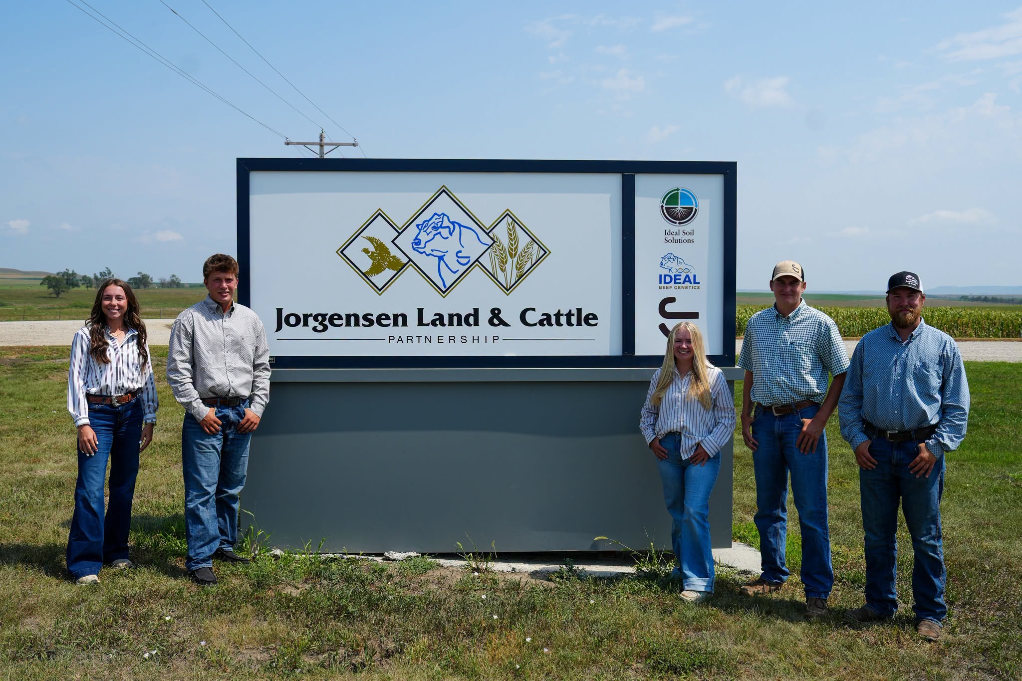 The 2026 Jorgensen Land & Cattle interns and team members standing beside the ranch sign